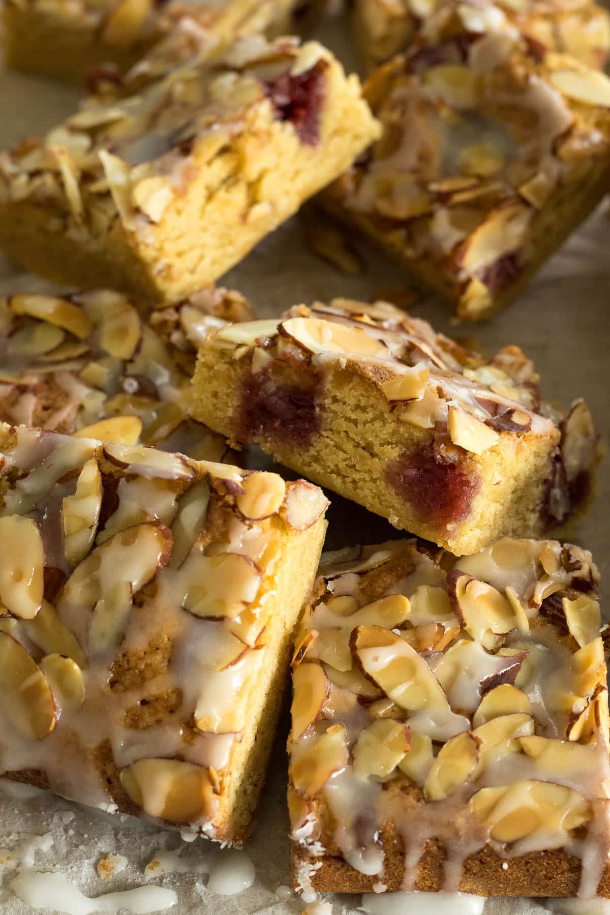 Sliced Bakewell Blondies on a baking paper.