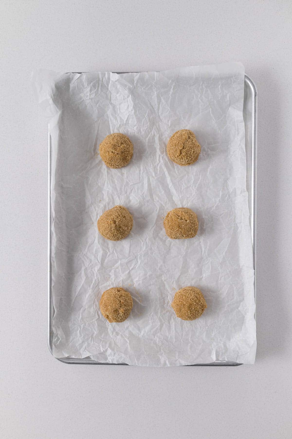 Step 6 - Portioned ginger cookies rolled in ginger-sugar.
