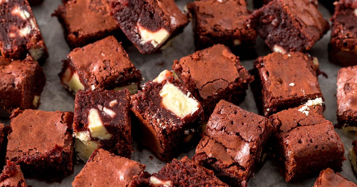 Close up of sliced red velvet brownie bites showing white chocolate chunks.