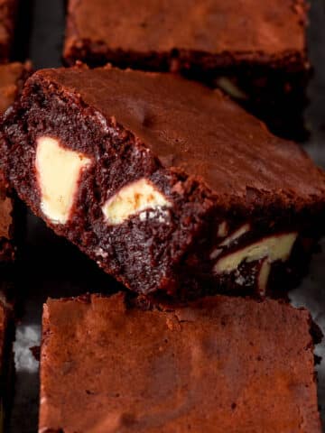 Close up of sliced red velvet brownie showing white chocolate chunks.