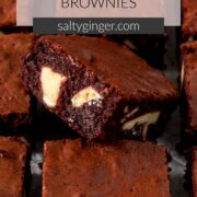 Pin - Close up of sliced red velvet brownie showing white chocolate chunks.