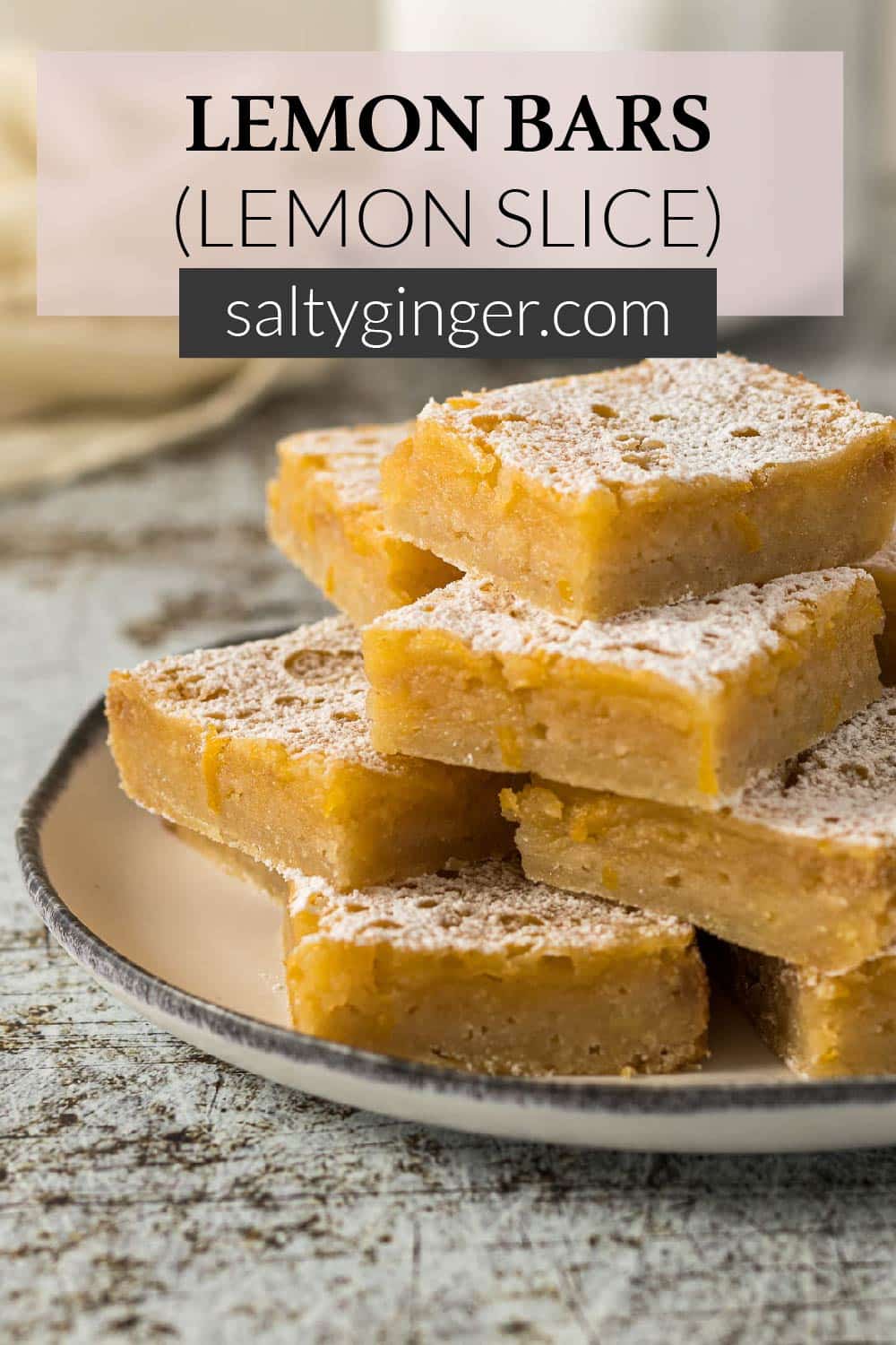 Pin - Lemon bars stacked on a plate.