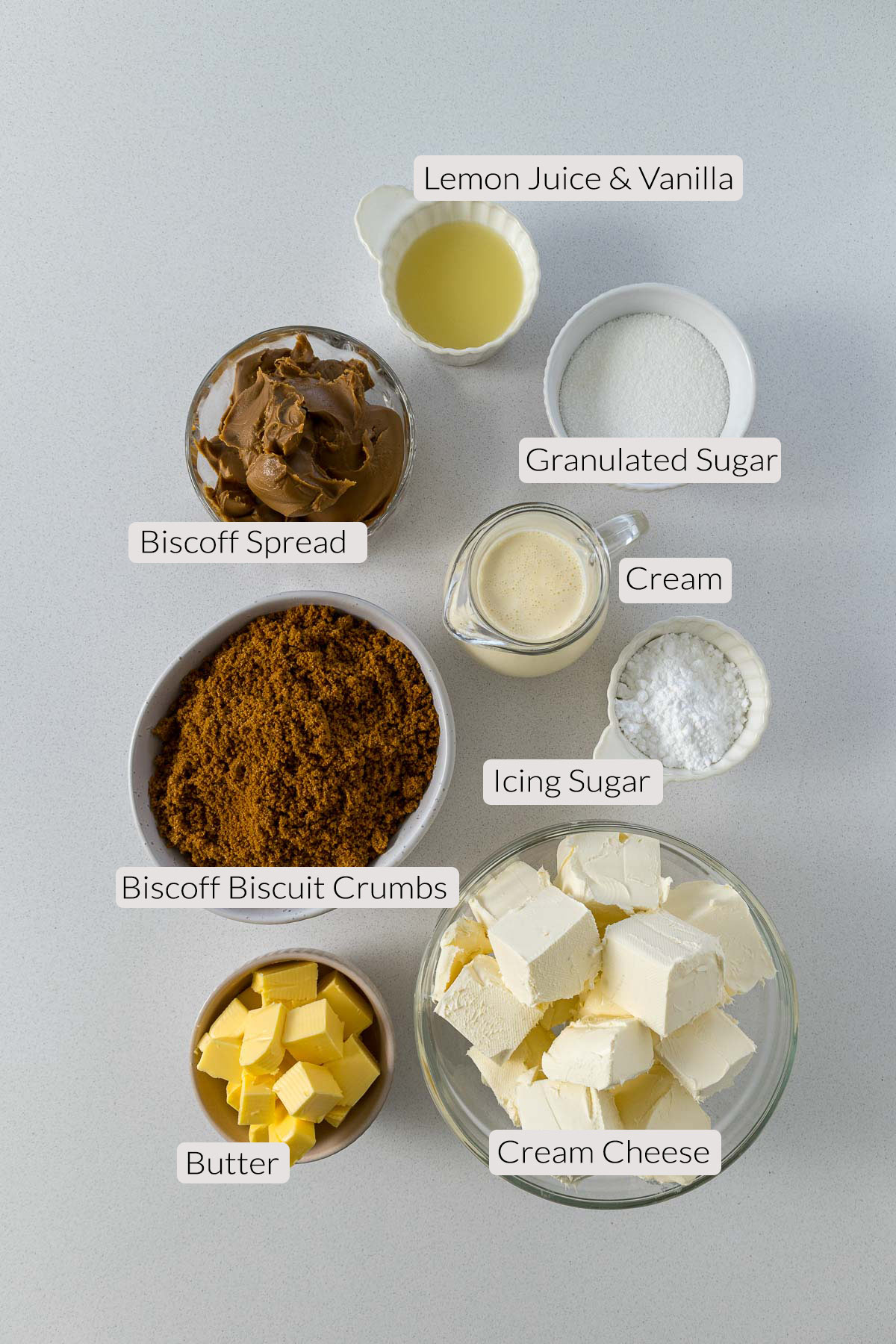 Biscoff Cheesecake Ingredinets - lemon juice, vanilla, sugar, icing sugar, cream, Biscoff spread, Biscoff Biscuits, butter, and cream cheese.