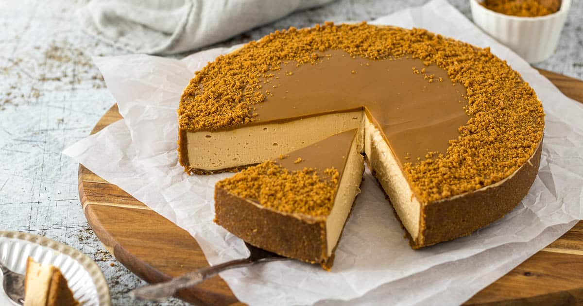 Sliced Biscoff cheesecake on a serving platter.