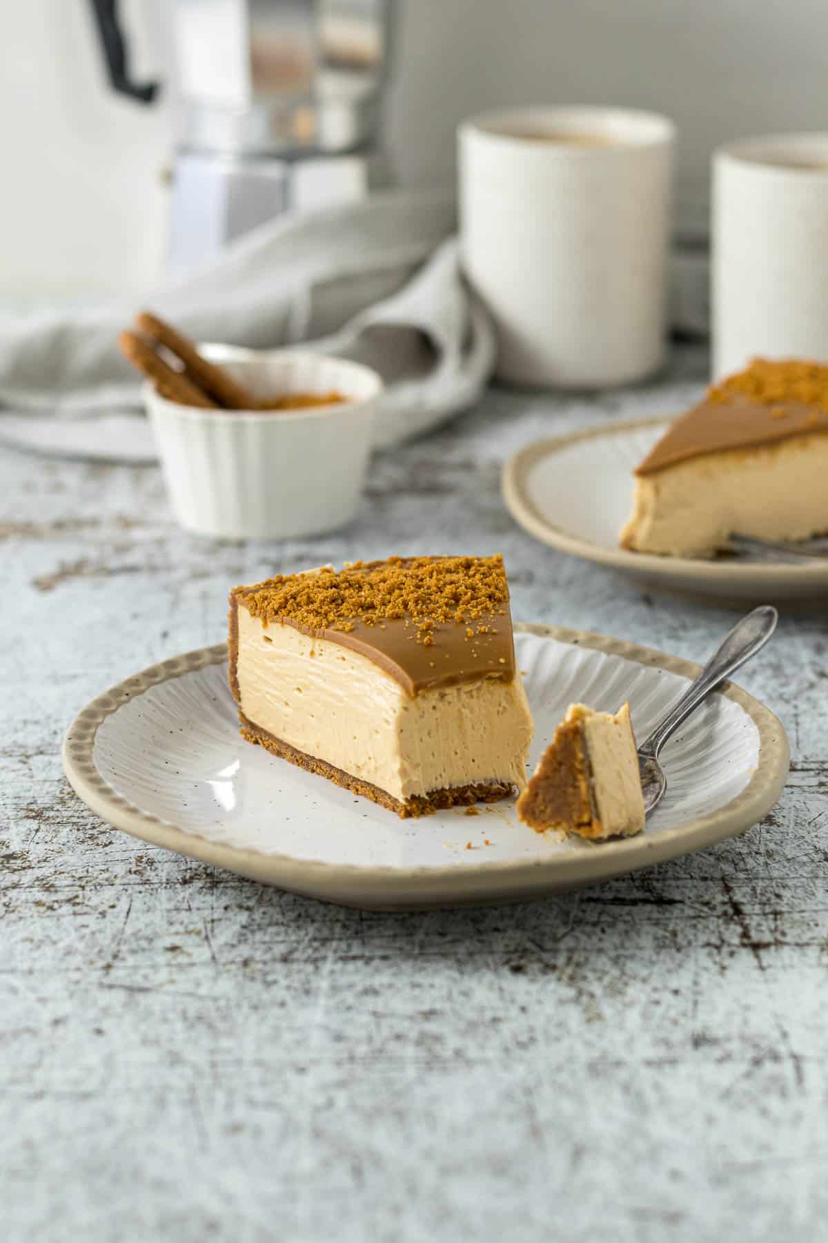 Slice of Biscoff cheesecake on a plate with a fork.