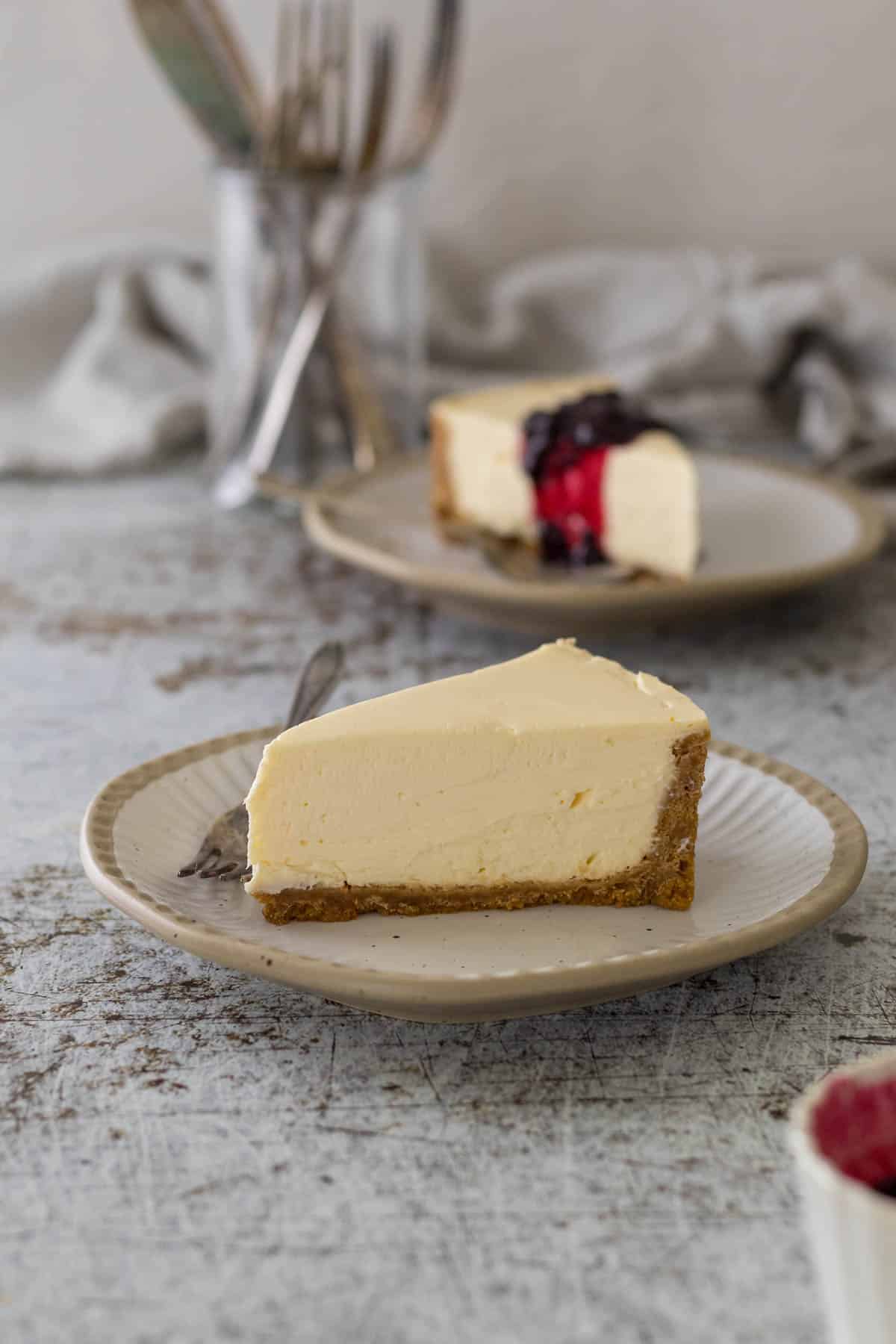 Slice of no-bake cheesecake on a plate with no toppings. 
