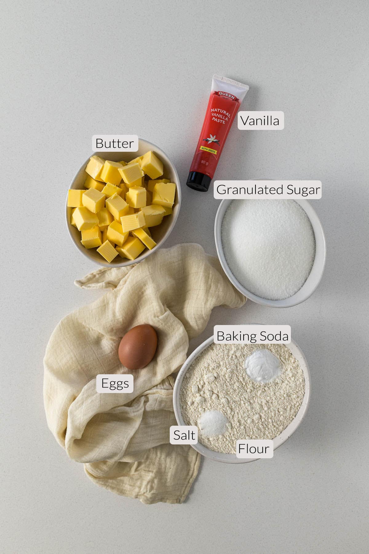 Vanilla sugar cookies ingredients - butter, vanilla, sugar, egg, flour, baking soda, and salt.