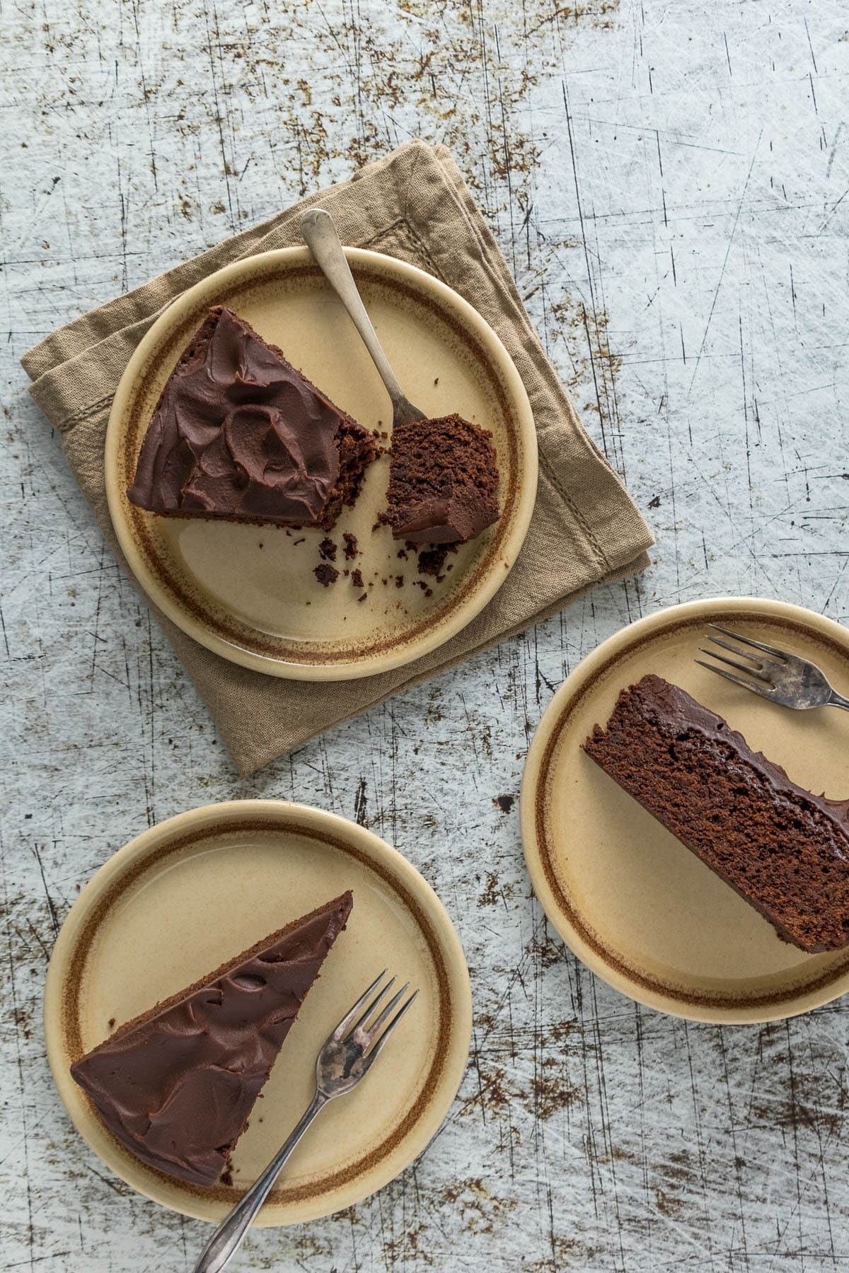 Slices of chocolate fudge cake on plates.