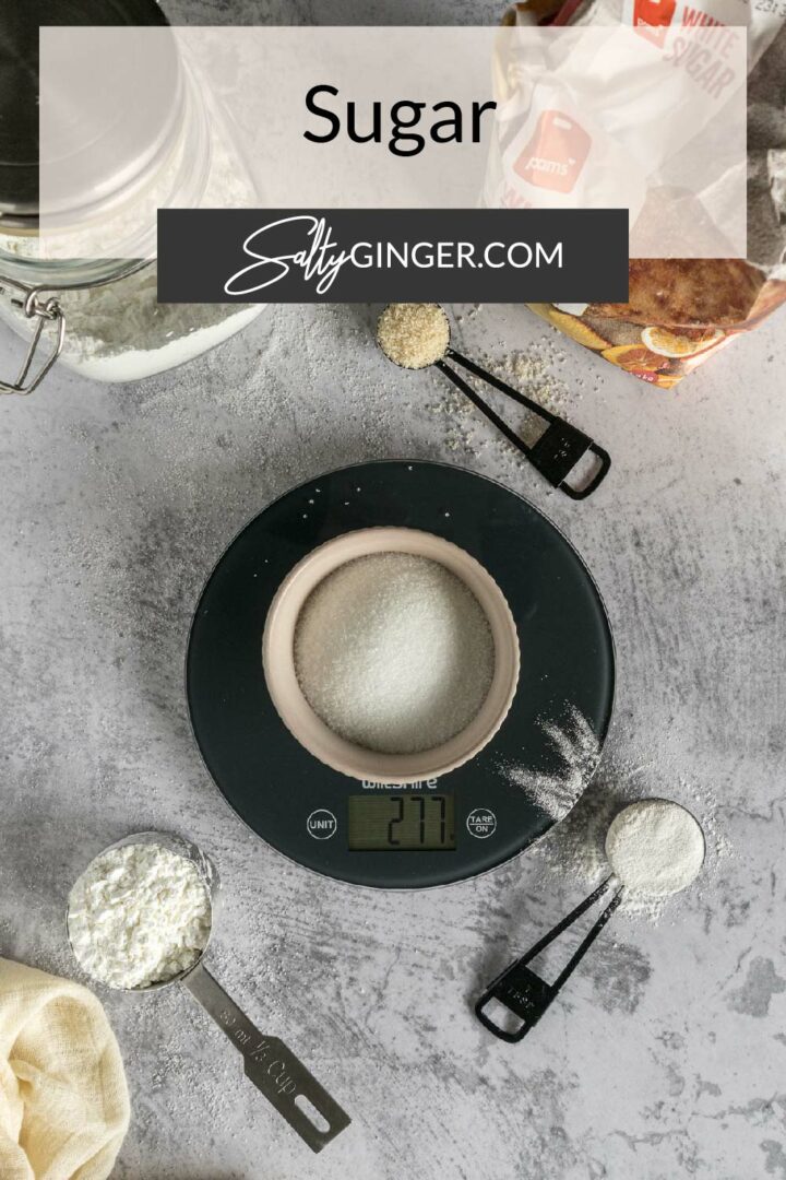 Pin - Sugar (weighing sugar on a kitchen scale).