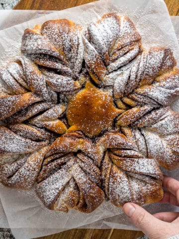 Nutella Star Bread dusted with powdered sugar on a serving platter.