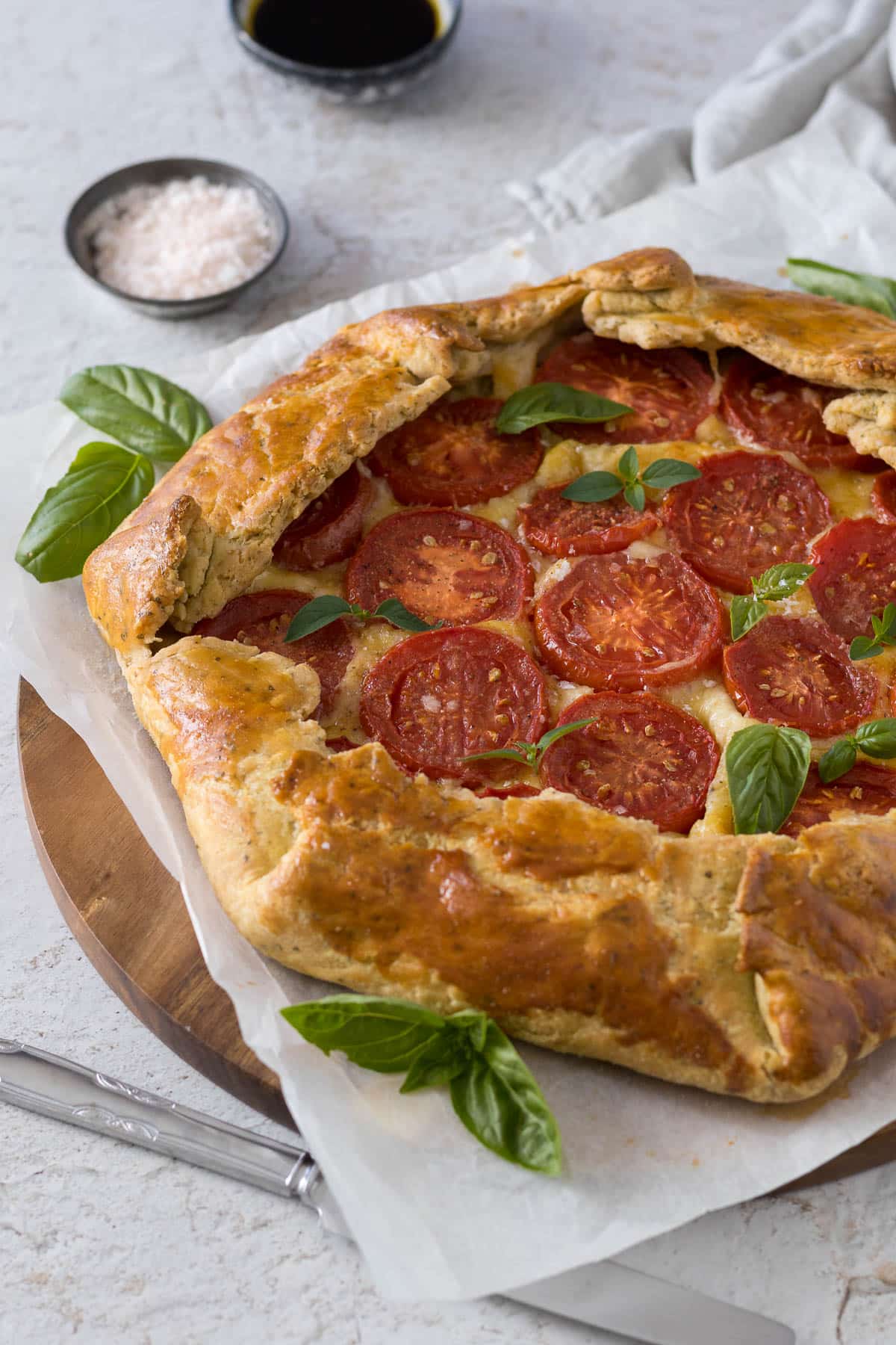 Savory galette served with fresh herbs and flaky salt.