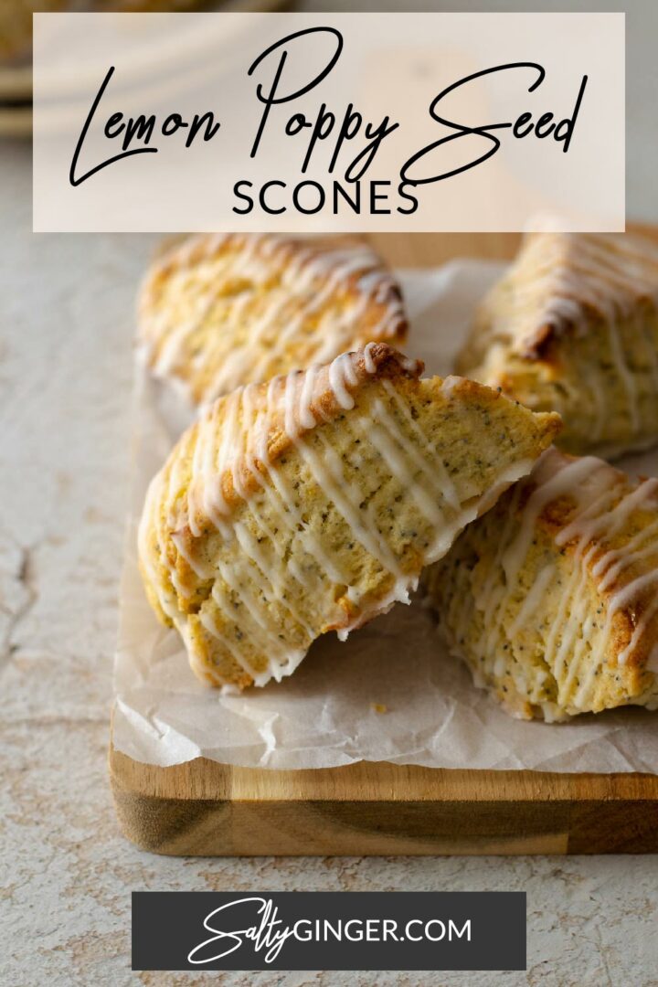 Pin - Lemon scones with poppy seeds and a lemon glaze on a serving board.