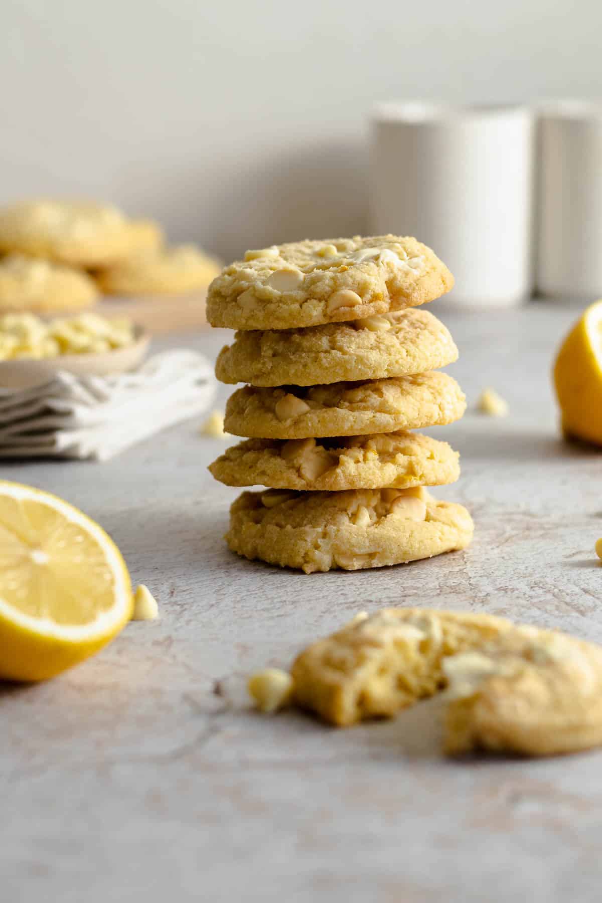 Lemon and white chocolate chip cookies stacked on each other.