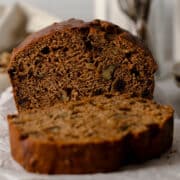 Sliced date and walnut cake showing the dates and walnuts in the cake.