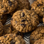 Oatmeal cookies with raisins on a baking tray.
